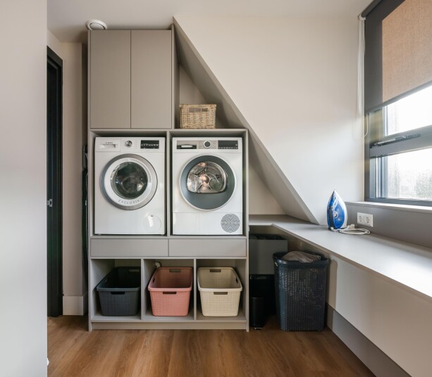 Bijkeukenkast op maat met wasmachine en droger achter maatwerkdeuren